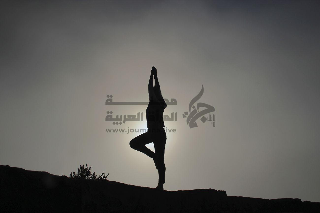 A woman doing yoga on a sloping